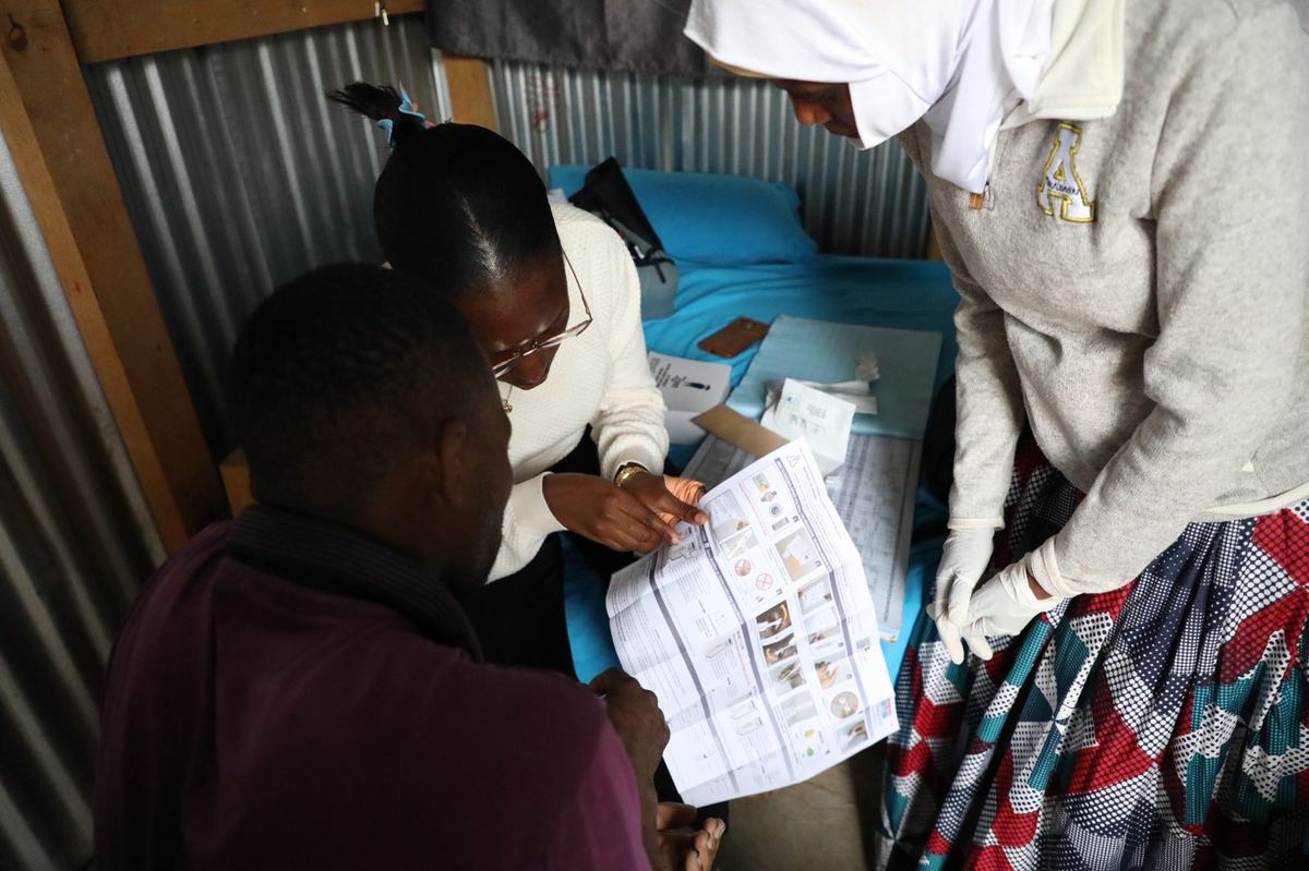 EpiC community health worker reviewing HIV self-testing instructions with clients